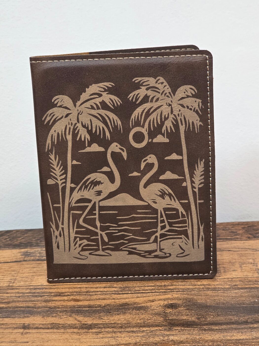 Brown passport cover engraved with flamingos